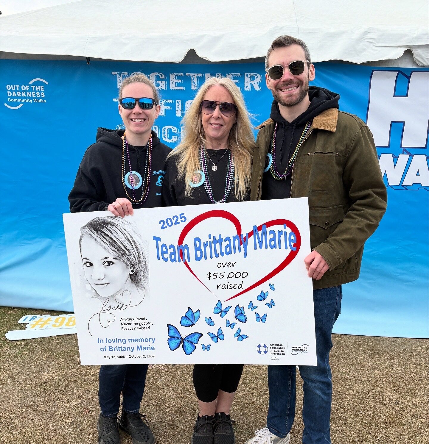 Zack and his family at the Out of the Darkness walk with the Team Brittany sign