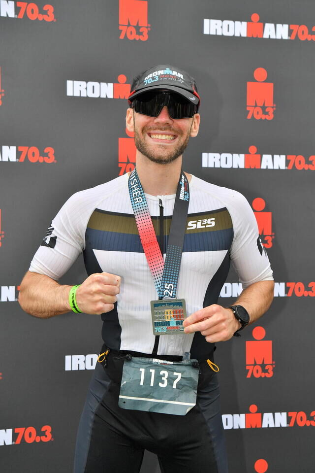 Zack after completing an Ironman 70.3