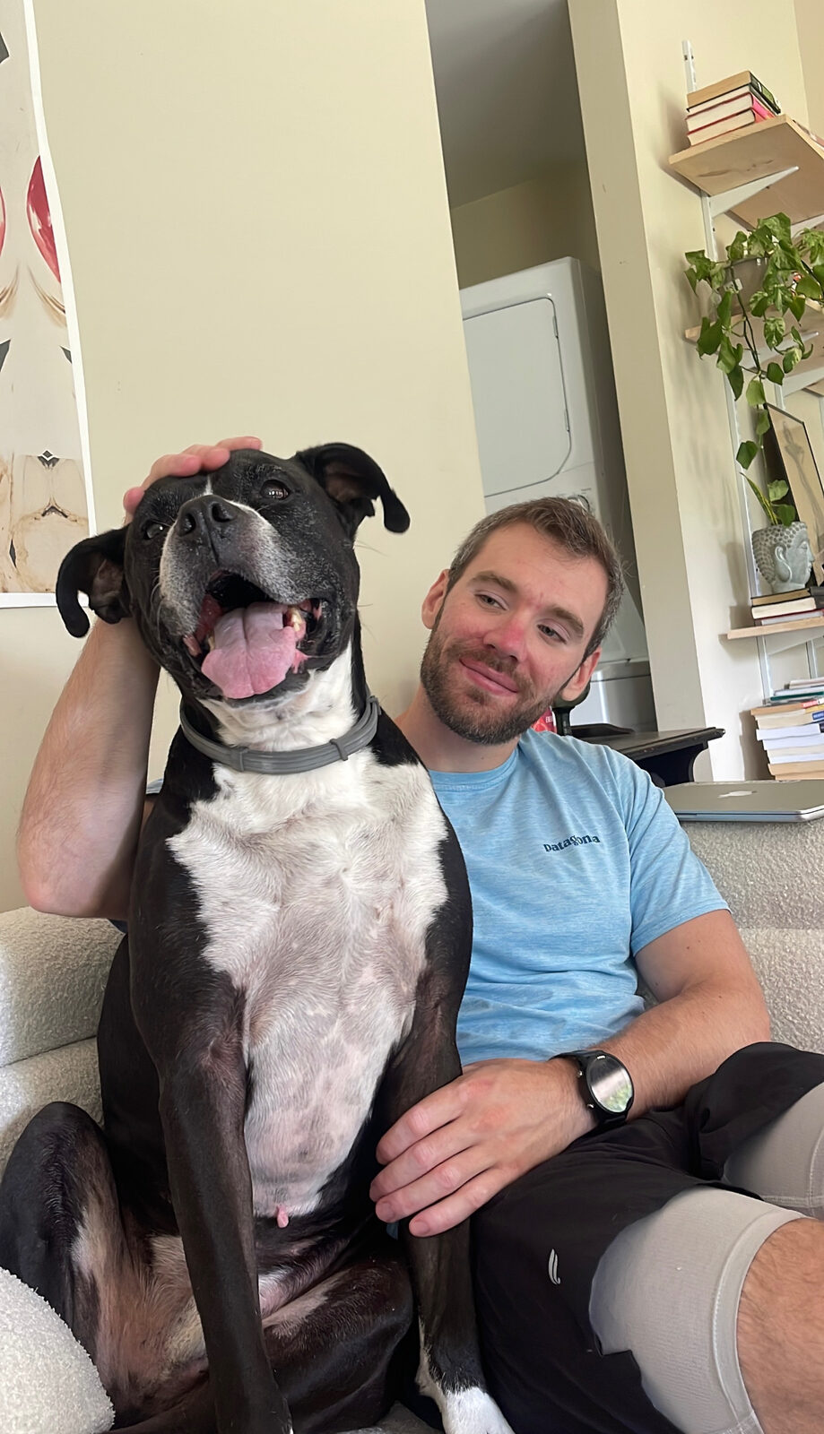 Zack on the couch with his dog, Oakley